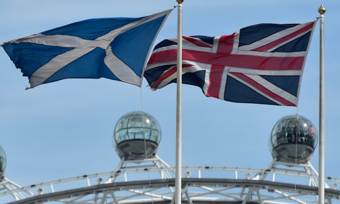 The Scottish saltire flag and Union flag fly outside the Scottish Office in central London